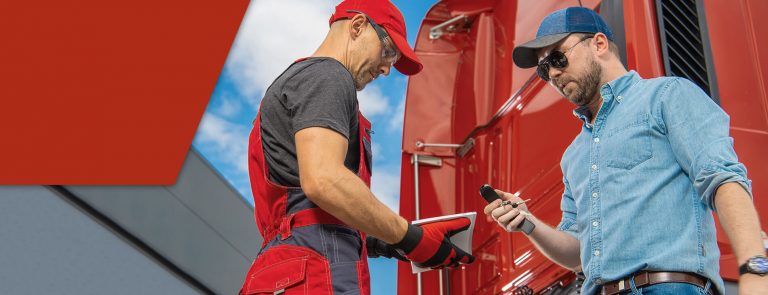Two male truckers discussing types of CDL restrictions